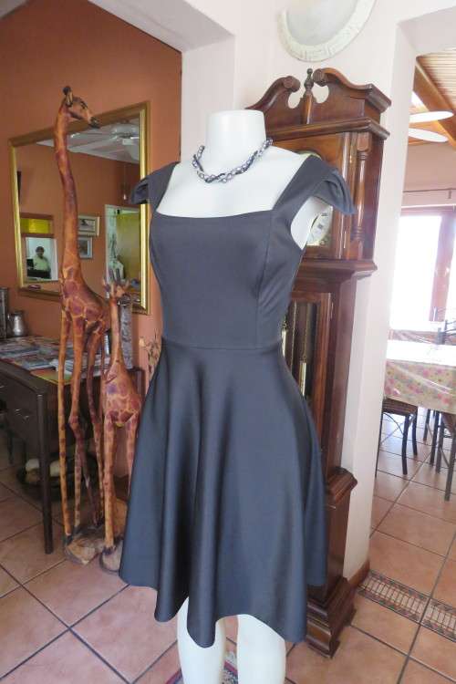 Sexy but smart black stretch polyester dress with half flare in size 32/8.Braiding at back.New cond.