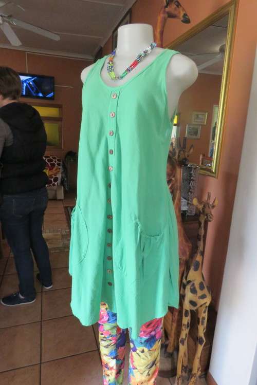 Get noticed in the long parakeet green A-line cut top in 100% cotton. Made in Thailand. Size 38/40.