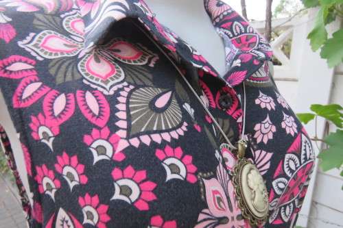 Black shirt dress with bo-ho print in different pinks. Button down front. Size 36/12.