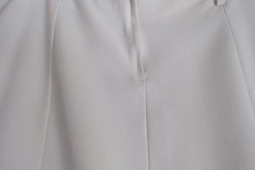 Up style off-white pencil skirt with pleated seam area. Size 40/16 by 'Inspire'.