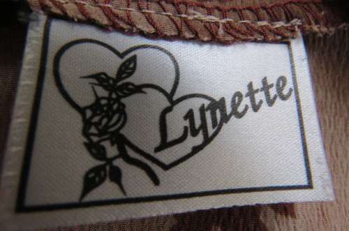 Button down dress in light brown with darker patches and dark brown flowers. Size 44/20.