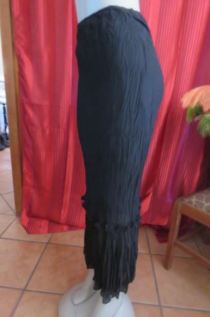 Floor length black crinkled polyester, fully lined skirt in size 32/8 by `Sassi`. Elasticated waist.