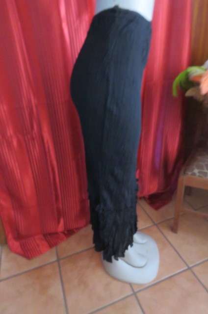 Floor length black crinkled polyester, fully lined skirt in size 32/8 by `Sassi`. Elasticated waist.