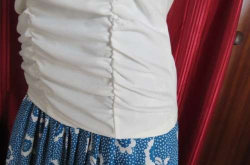 Femininei white top with square sequined neckline. Sleeveless size 36/12.In polyester/nylon.As new