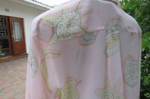 Sheer polyester long sleeve top in pale peach colour. Size 38/14 by 'Giorgio'. Cuffed sleeves.