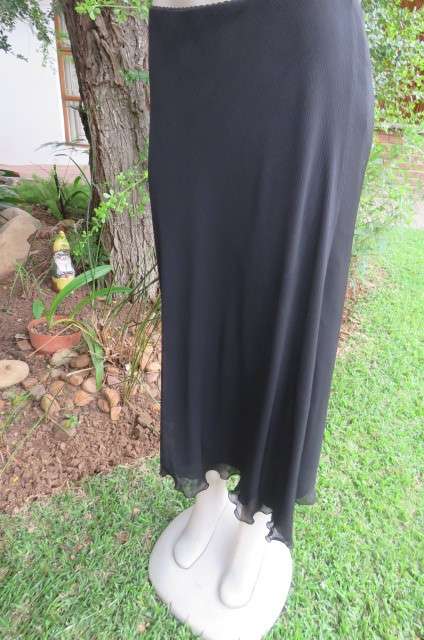 You can pair this smart black A-line skirt in 2 layers with a range of matching tops size 36/12.
