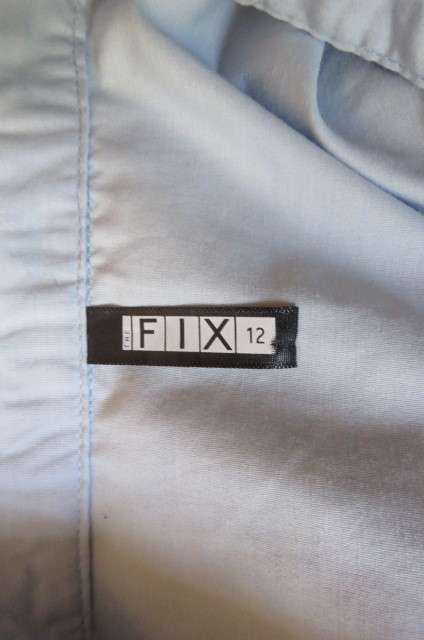 Styled powder blue long sleeve top by 'Fix'in size 36/12. Hidden button down front with shirt collar