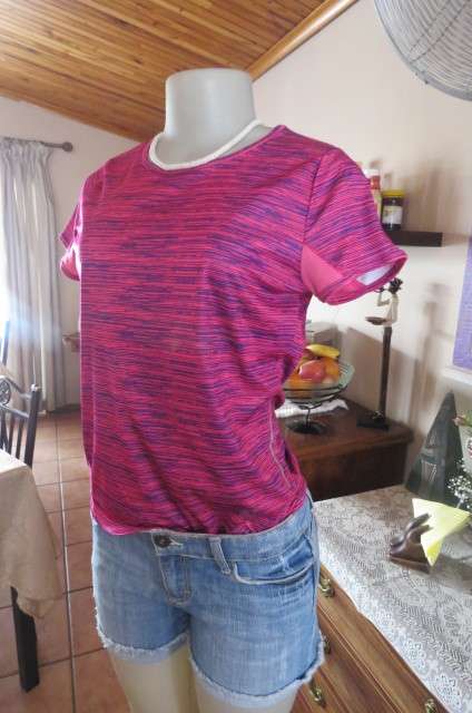 Sports top in size 30/6 by 'Maxed'. In royal blue and magenta pink vertical print. Capped sleeves.