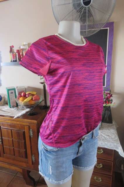 Sports top in size 30/6 by 'Maxed'. In royal blue and magenta pink vertical print. Capped sleeves.