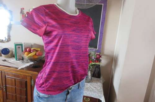 Sports top in size 30/6 by 'Maxed'. In royal blue and magenta pink vertical print. Capped sleeves.