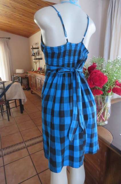 Cute blue and black check strappy dress by 'Legit' in size 40/16. Adjustable straps. Panelled front.