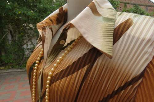 Unique permanent pleated short sleeve top in size 44/20. Button down front with shirt collar.