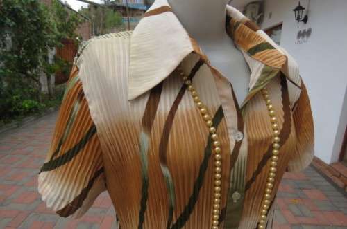 Unique permanent pleated short sleeve top in size 44/20. Button down front with shirt collar.