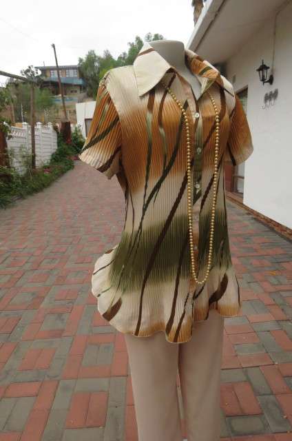 Unique permanent pleated short sleeve top in size 44/20. Button down front with shirt collar.