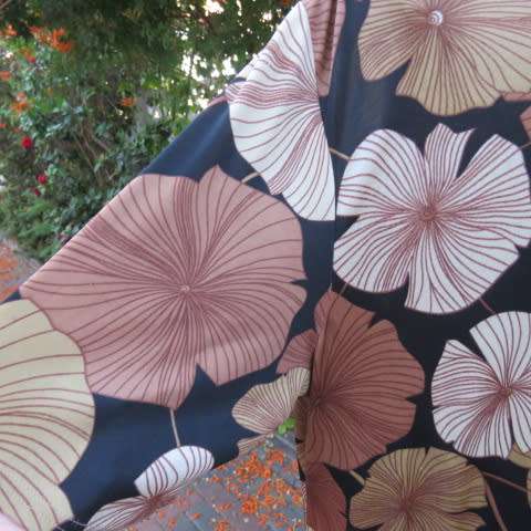 Silky dark brown slip over top with bold beige,gold and brown floral pattern. Short sleeves. Size 50