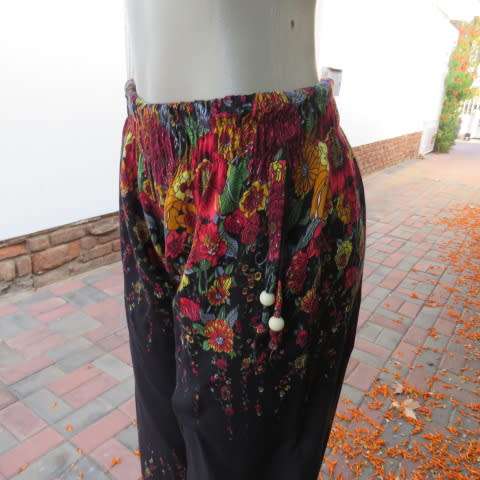 Palazzo pants in black with pretty colourfyl borders in crimson,yellow,mustard and green. Size 34/10