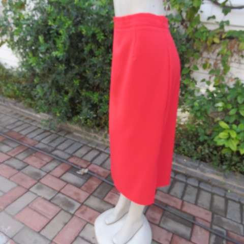 Smart red ankle length pencil style skirt in 100% wash and wear polyester. Slitted sides. Size 44/20