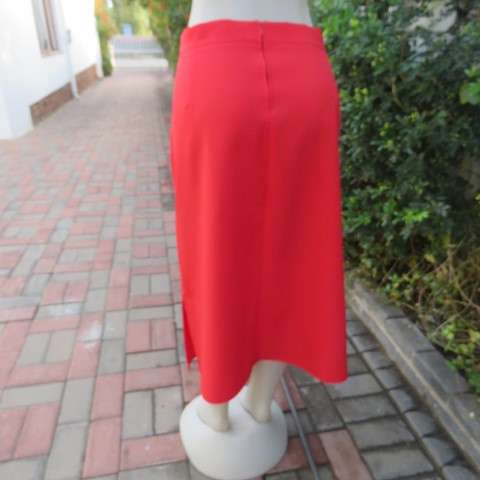 Smart red ankle length pencil style skirt in 100% wash and wear polyester. Slitted sides. Size 44/20