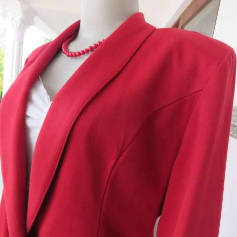 Show stopping red peacoat style long sleeve jacket closing with 2 buttons. Pleats at back.Size 34/10