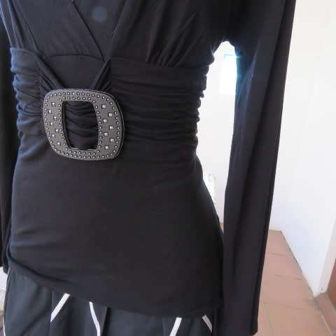 Fabulous used black sexy long sleeve top from IQ in size 38/14.Low plunging neckline.Front buckle