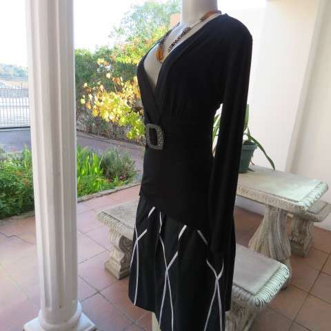 Fabulous used black sexy long sleeve top from IQ in size 38/14.Low plunging neckline.Front buckle
