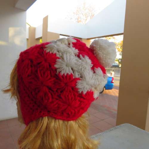 Warm earflap hat with ties for those cold days. New condition with pom pom.