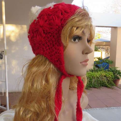Warm earflap hat with ties for those cold days. New condition with pom pom.
