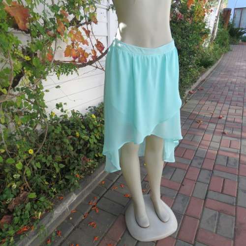 Sexy pale turquoise asymetric skirt with fold over front. Size 36/12. Sheer polyester partly lined.