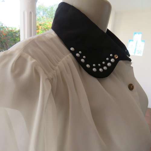 Smart white sheer polyester long sleeve blouse with gathered yokes.Black embellished collar.Size 38