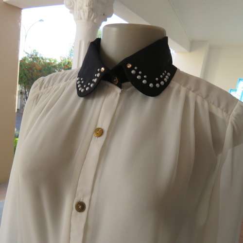 Smart white sheer polyester long sleeve blouse with gathered yokes.Black embellished collar.Size 38