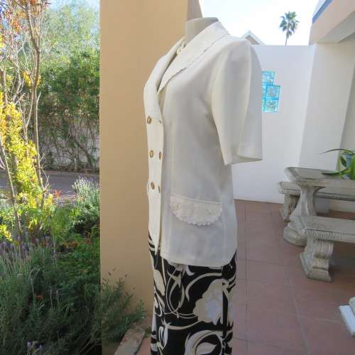 Very smart and elegant size 34/10 double breast cream top with pretty embroidery and lace decoration