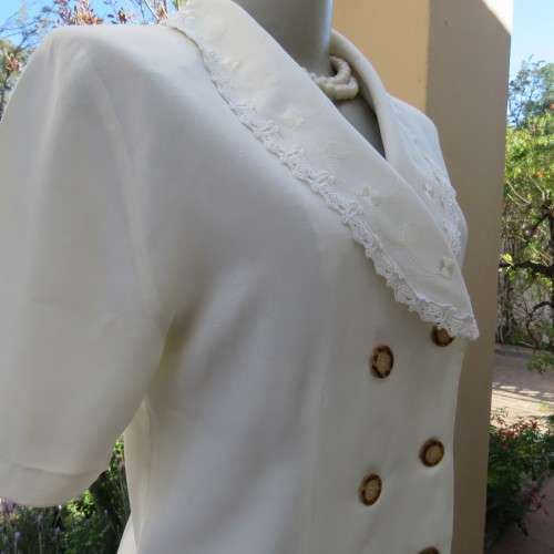 Very smart and elegant size 34/10 double breast cream top with pretty embroidery and lace decoration