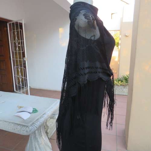 Black triagle throw 150cm x 115cm x 115cm. Floral pattern on mesh look with fringed borders.