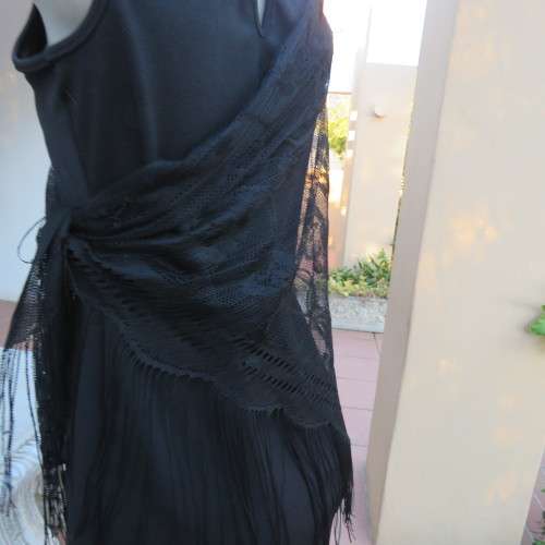 Black triagle throw 150cm x 115cm x 115cm. Floral pattern on mesh look with fringed borders.