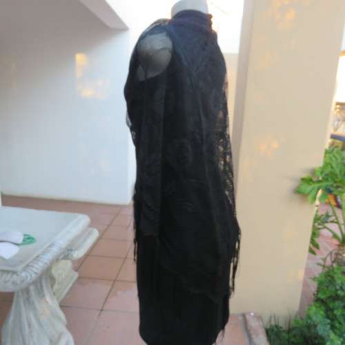 Black triagle throw 150cm x 115cm x 115cm. Floral pattern on mesh look with fringed borders.