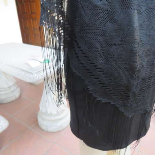 Black triagle throw 150cm x 115cm x 115cm. Floral pattern on mesh look with fringed borders.