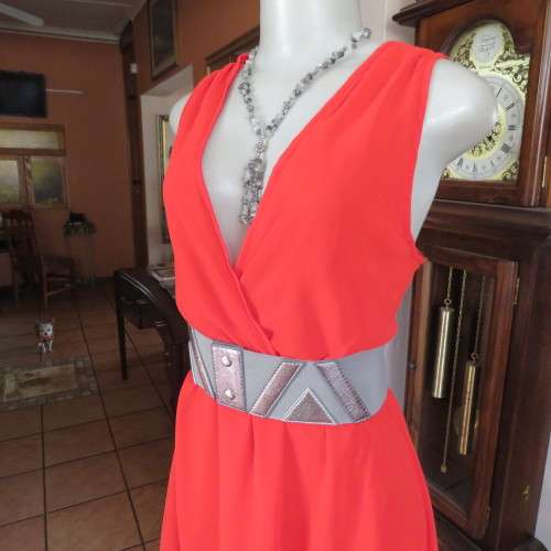 Sexy bright red sheer polyester dress with lining. Mini length on front size 38/14. Good condition.