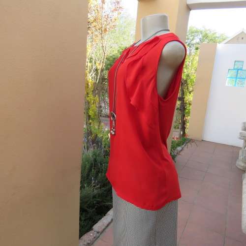 Pretty bright red sleeveless top with stretch viscose back and polyester front size 40/16. As new.