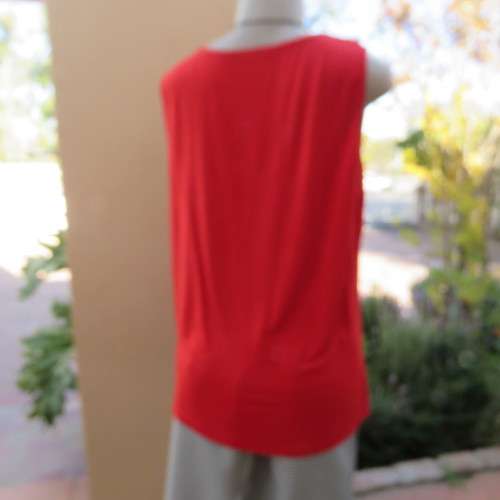 Pretty bright red sleeveless top with stretch viscose back and polyester front size 40/16. As new.