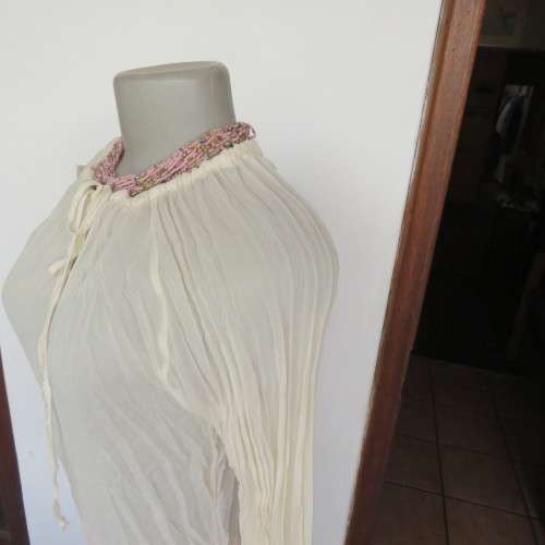 Pretty long permanent creased high-low cream top with long angel point sleeves size 32/8. As new.