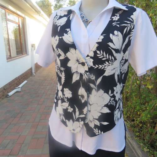 Smashing new navy and white floral fully lined waistcoat by ELBETH in size 36/12. Button down.