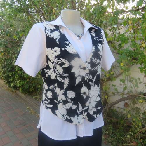 Smashing new navy and white floral fully lined waistcoat by ELBETH in size 36/12. Button down.