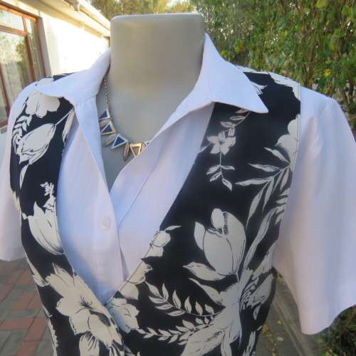 Smashing new navy and white floral fully lined waistcoat by ELBETH in size 36/12. Button down.