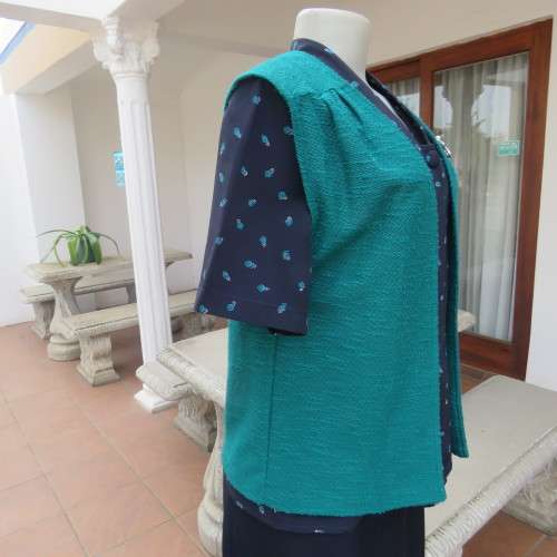 Textured teal colour open hanging sleeveless top in size 38/14. With pleats on front. As new.