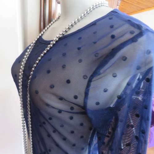 Smart long sleeve navy top in stretch netting  with embossed dots. Size 36/12 by RT. Good condition