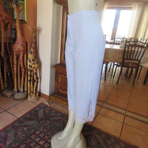 Fabulous cropped powder blue high waist pants crochet decoration on legs. Size 34/10 New condition.