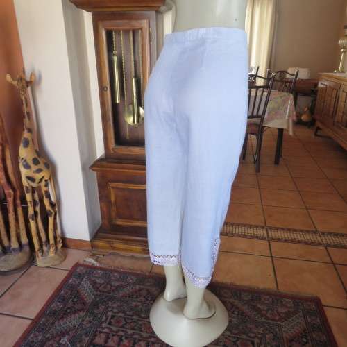 Fabulous cropped powder blue high waist pants crochet decoration on legs. Size 34/10 New condition.