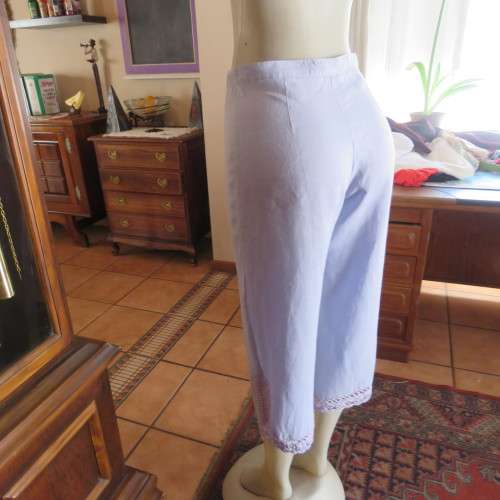 Fabulous cropped powder blue high waist pants crochet decoration on legs. Size 34/10 New condition.