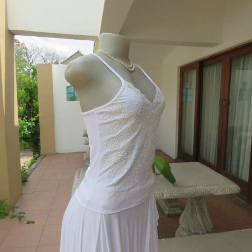Embellished slip it over strappy top. For evening or day wear. Size 32 to 34. New condition.