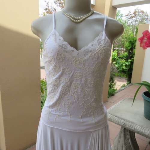 Embellished slip it over strappy top. For evening or day wear. Size 32 to 34. New condition.